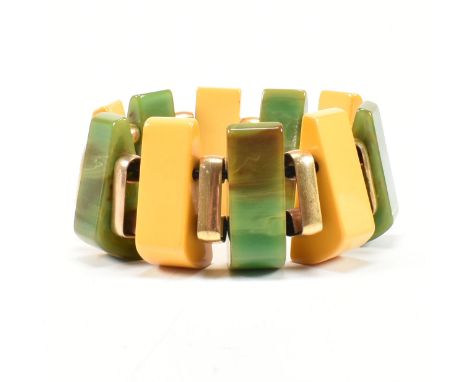 A 1930's Art Deco Bakelite wedge stretch link cuff bracelet. The bracelet bangle formed with marbled green and yellow Bakelit