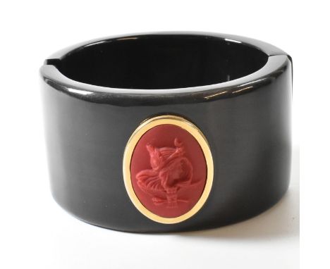An Extasia buffalo horn hinged bangle with cameo. The Extasia black buffalo horn hinged bangle having a central red oval Ital