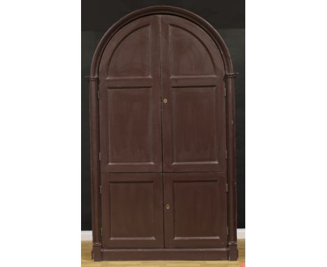 A substantial late Victorian pine architectural servants' quarters provision cupboard, arched top above two pairs of panel do