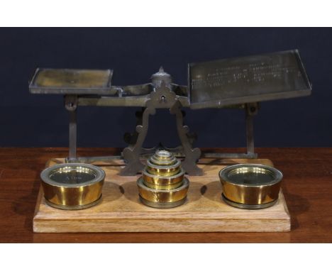A set of Victorian oak and brass parcel post letter balance scales, the larger plateau inscribed with rates and insurance, 42