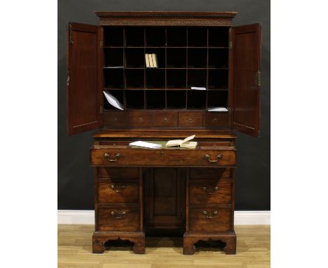 A George III mahogany estate office cabinet on desk, dentil cornice above a blind fretwork frieze and a pair of raised and fi