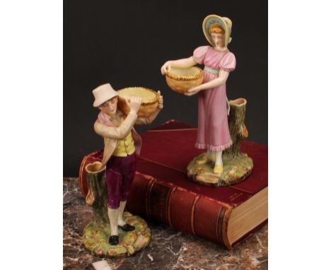 A pair of Royal Worcester figural spill vases, modelled as a boy and girl, each carrying a basket, shaped naturalistic bases,