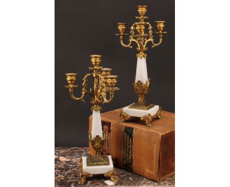 A pair of Louis XVI style gilt metal mounted three branch four light candelabra, 38cm high 