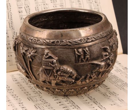 An Indian/Burmese silver circular bowl, chased in bold relief with a hunting party under attack, 15.5cm diam, c.1880, 810g 