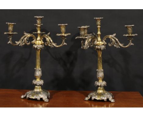 A pair of substantial 19th century electro-plated and parcel-gilt five-light table candelabra, campana sconces, acanthus scro