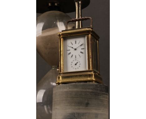 An early 20th century French lacquered brass miniature carriage timepiece, 3.5cm enamel clock dial inscribed with Roman numer