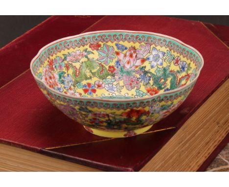 A Chinese lobed circular dragon bowl, decorated in polychrome enamels on a yellow ground, 14cm diameter, red seal mark, 20th 