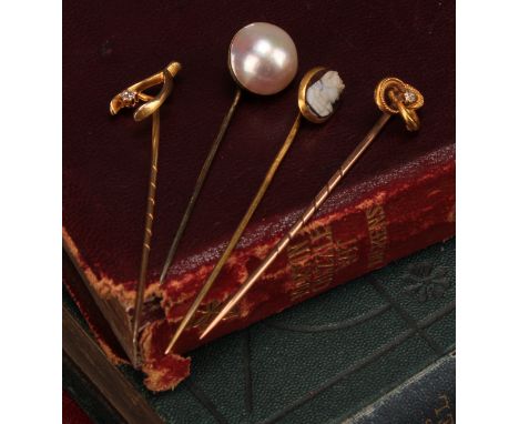 Stick Pins - a 19th century 15ct gold wishbone stick pin, set with a single diamond, stamped '15ct', 1.3g gross; a 15ct gold 
