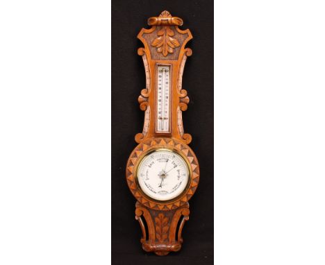 A late Victorian oak wheel barometer, 12cm circular register inscribed JOHNSON &amp; SON., DERBY, the case carved with scroll