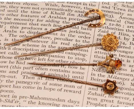 Stick Pins - a late 19th century 15ct gold novelty stick pin in the form of a thistle, amber glass flower bud, stamped '15ct'