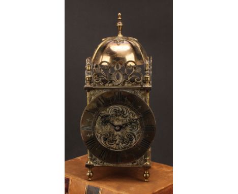 A 17th century style brass lantern clock, 17cm chapter ring inscribed with Roman numerals, twin winding holes, eight day move