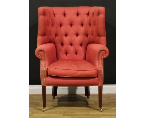 A George III style barrel-back porter’s chair, stuffed-over upholstery, deep-button back, scroll arms, squab cushion, tapered