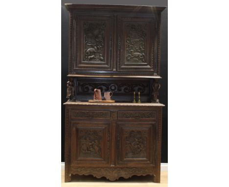 A late 19th century French provincial chestnut Breton buffet cabinet, moulded cornice above a pair of panel doors carved with