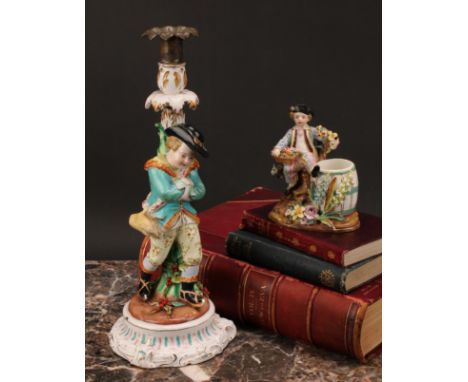 A John Bevington porcelain figural candlestick, allegorical of Winter, as a skater with turquoise jacket and rabbit in his kn
