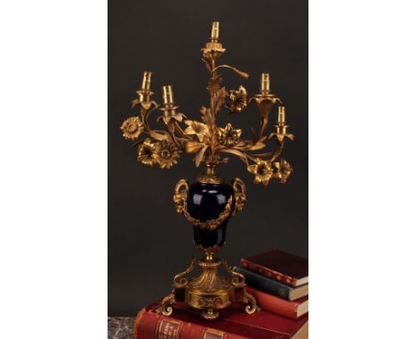 A mid 19th century Louis XVI style gilt metal and porcelain five light candelabrum, probably Sevres, the branches naturalisti
