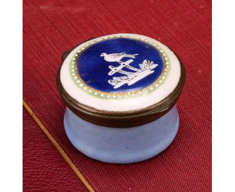 A George III South Staffordshire enamel circular patch box, hinged cover decorated in white with a perched bird, within a bea