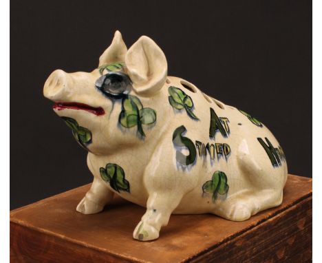 A 19th century English pottery posy vase, modelled as a pig, in the manner of Wemyss, painted in tones of green and yellow, w