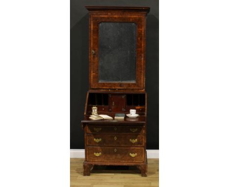 An 18th century burr yew bureau book cabinet, moulded cornice above a mirrored door enclosing a shelf and three small drawers