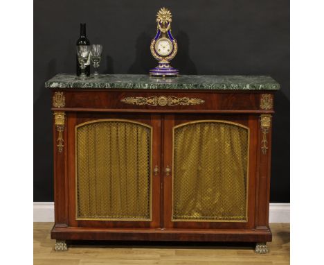 A French Empire design gilt metal mounted mahogany side cabinet, marble top above a pair of pleated fabric panel doors, appli