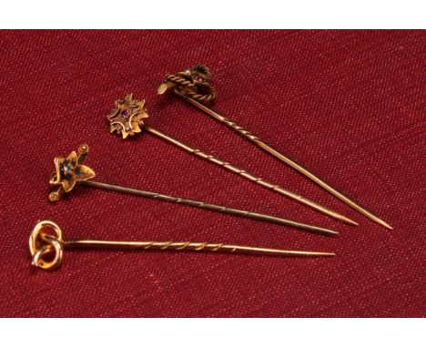 Stick Pins - a late 19th century 15ct gold rope twist stick pin, set with a ruby and seed pearl, marked, 1.3g; a 15ct gold iv