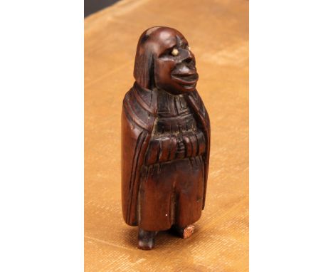Snuff - A 19th century French novelty treen snuff box, carved as a man in a long cape clasping his hands, bone eyes, 8.5cm hi