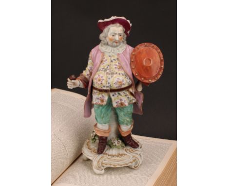A Derby patch mark figure, Quinn as Sir John Falstaff, he stands holding an oval shield, wearing a broad brimmed hat, a doubl