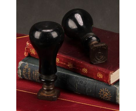 A pair of 19th century armorial desk seals, heraldic matrices with intaglio coats of arms and motto God For Us, turned ebonis