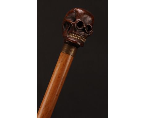 The Macabre - an early 20th century memento mori walking stick, the oak pommel carved as a skull with pierced eye sockets and