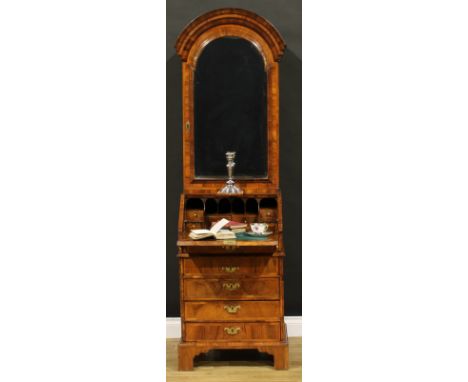 An 18th century walnut bureau book cabinet, of narrow proportions, dome top with bevelled glazed door enclosing an architectu
