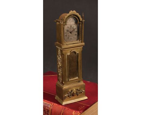 An early 20th century lacquered brass novelty timepiece, as a miniature longcase clock, 5cm arched silvered dial inscribed Fr