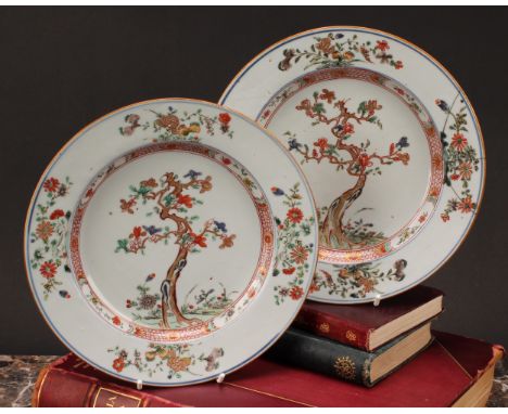 A pair of Chinese famille verte porcelain plates, the central well painted with cherry blossom and butterflies within a folia