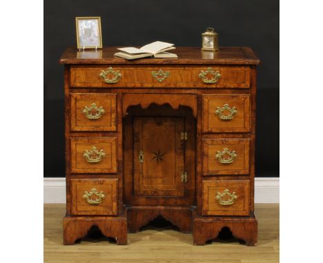 A George II walnut kneehole desk, burr-banded quarter-veneered rectangular top with moulded edge above an arrangement of draw