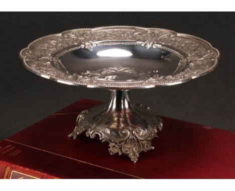 A Victorian silver table centre tazza, embossed with a border of flora and scrolls, 11.5cm high, 23.5cm diameter, Fenton Brot