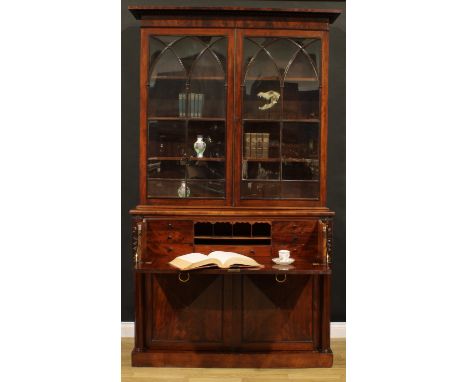 A George IV mahogany secretaire bookcase, gadrooned cornice above a pair of astragal glazed doors with lancet bars enclosing 