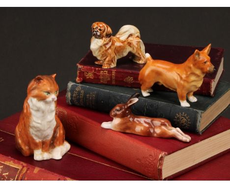 A Royal Worcester model, of a Corgi, 9cm long, printed mark in black, shape 3243, date code for 1955; others, a Pekinese, 6.5