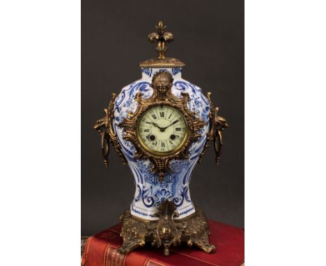 A late 19th/early 20th century French brass mounted Delftware mantel clock, 8.5cm circular dial inscribed with Roman and subs