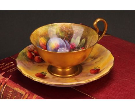 A Royal Worcester cup and saucer, matched, the cup painted by W.H. Austin, the saucer by E. Townsend, signed, with plums and 