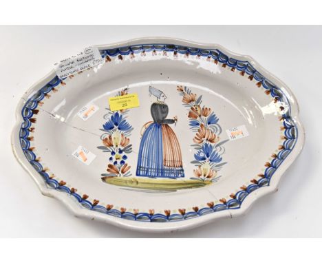 An early to mid 19th Century Quimper Breton platter measuring 34 x 26 cms unmarked with early staple repair