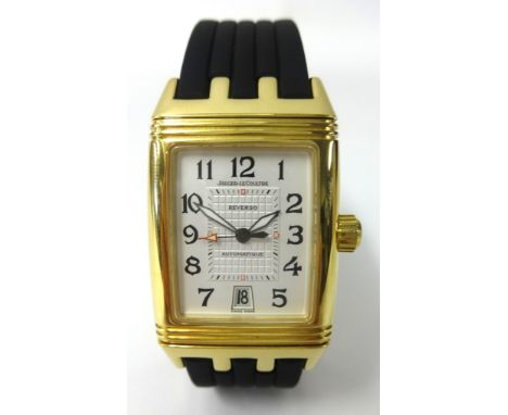 A Jaeger LeCoultre, a gents 18ct gold Reverso Grand Sport wristwatch, with black leather bracelet with original box and book 