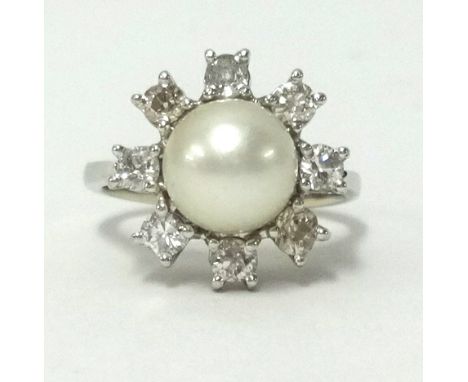 An 18ct white gold pearl and diamond set cluster ring, finger size J.