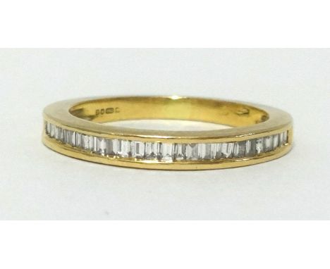 A 18ct half band eternity ring, set with baguette cut diamonds, finger size K/L.