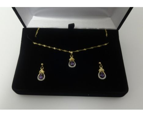 A 9ct amethyst and diamond pendant on fine gold chain and a matching pair of earrings en suite.