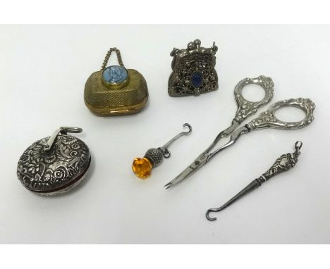 Chatelaine objects including silver pin cushion with repousse work, silver thistle button hook, silver scissors, button hook,