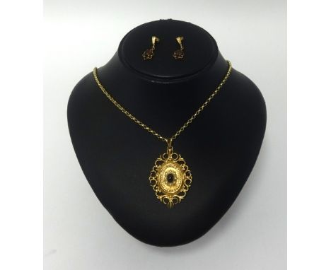 An antique garnet and seed pearl set pendant in yellow metal pendant on a fine chain also a pair of earrings