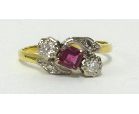 An 18ct ruby and diamond ring. finger size P.