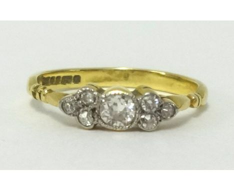 A 18ct gold diamond dress ring set with an arrangement of seven old cut diamonds, ring size J/K.