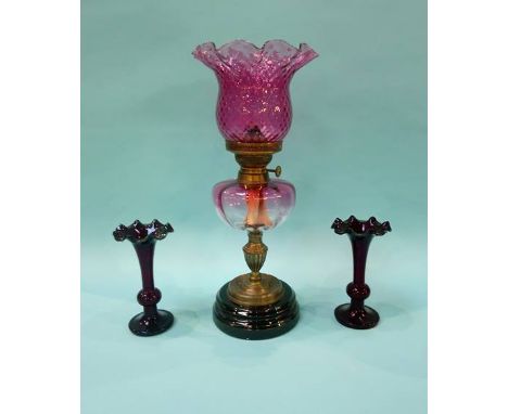 Oil lamp with cranberry glass reservoir and shade and a pair of vases