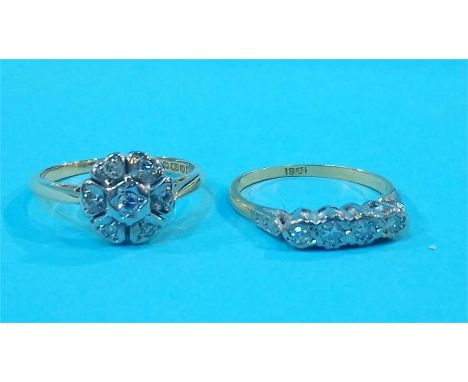 An 18ct four stone diamond ring and an 18ct gold diamond cluster ring