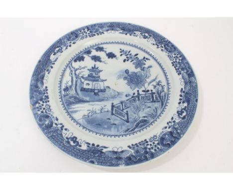 18th century Chinese export blue and white charger with Chinese pagoda, floral and fence decoration with butterfly and scroll