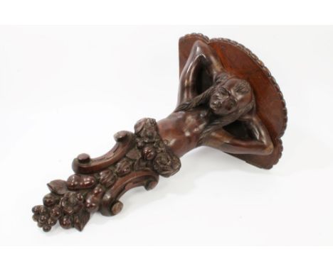 19th century carved oak wall bracket with shaped shelf, raised on carved male caryatid with floral and fruit C-scroll termina